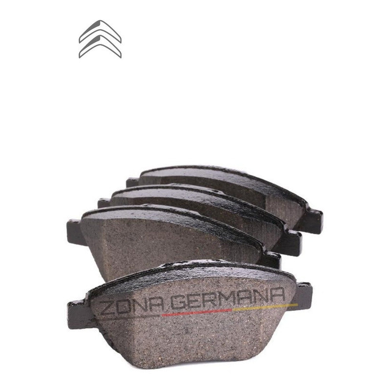 Set of four automotive brake pads for Citroën on white background